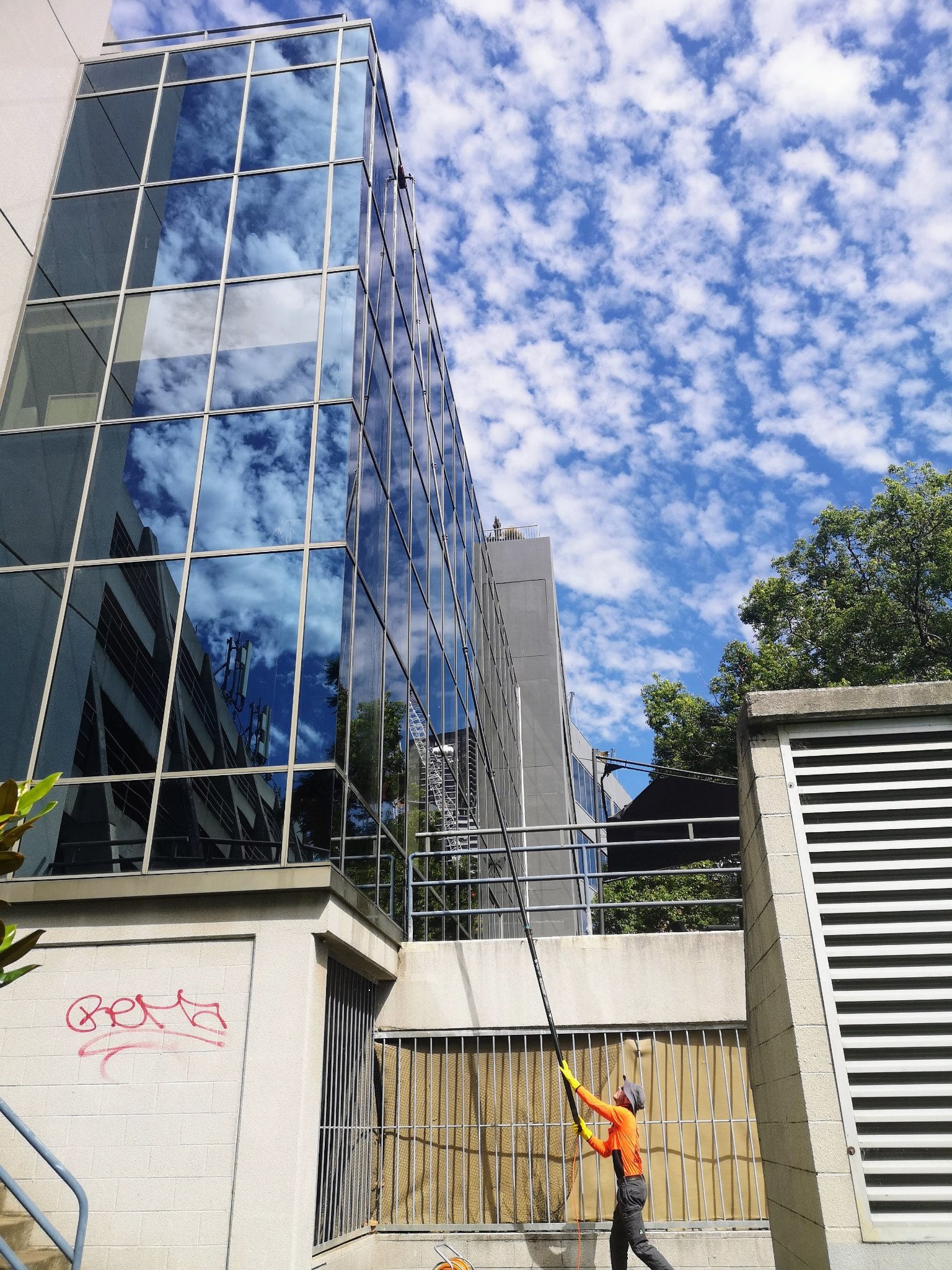 Professional window cleaning on commercial office building glass facade