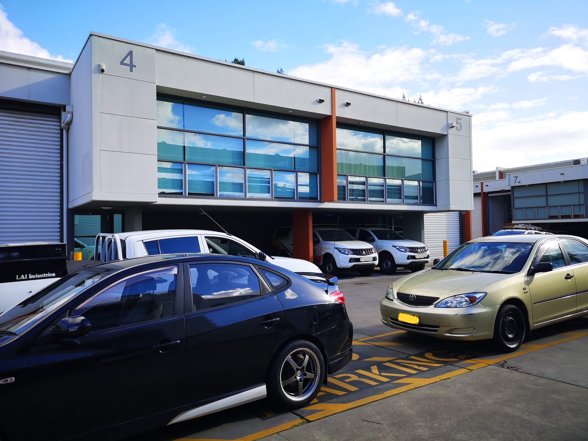Window cleaning on industrial building showroom and business unit glass frontage